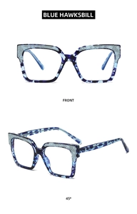 Detailed front and 45-degree view of blue hawksbill frames with silver glitter inlay