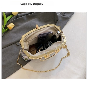 Internal view of floral embroidery bag showing large capacity for essentials and gold chain