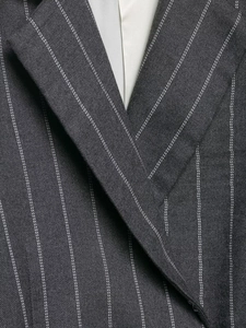 Macro detail of dark grey pinstripe suit lapel with visible fabric texture and white shirt