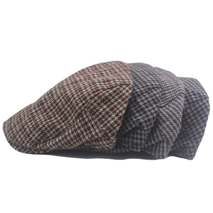 Three classic houndstooth flat caps in dark gray, light blue and brown wool blend