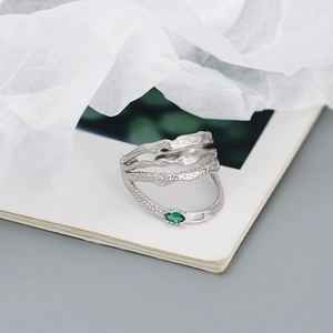 Detailed close-up of a silver irregular double-layer ring with a green marquise gemstone