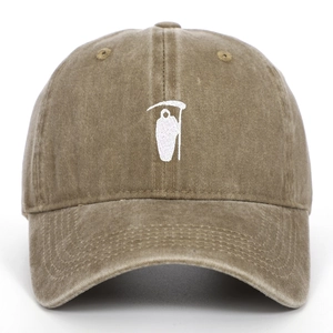 Detailed close-up of white Reaper embroidery on a vintage washed khaki cotton baseball cap