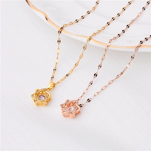 Detail of 18K rose gold and gold star pendants with zircon and purple gemstone