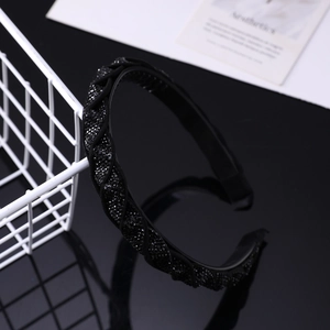 Detail of black woven headband with dense rhinestones and anti-slip teeth design