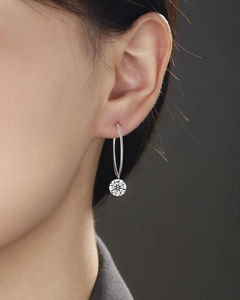 Close-up of elegant 925 silver hoop earring with a round brilliant moissanite stone
