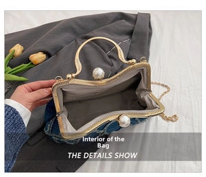 Interior detail of denim shell bag with pearl clasp and classic herringbone lining