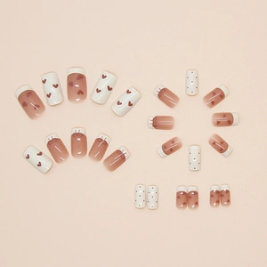 French ballet press-on nails set with red hearts, dots and bow designs on glossy base