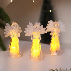 Close-up of three LED acrylic angel lights with warm glow for Christmas decor