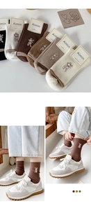 Detail of combed cotton mid-calf socks with cute rabbit embroidery in earth tones