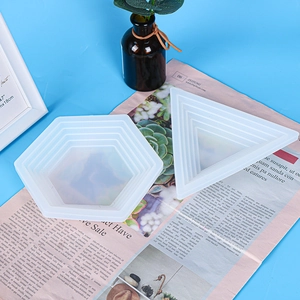 Detail of hexagonal and triangular silicone molds with tiered texture for resin casting