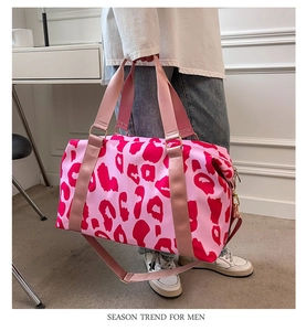 Detail view of pink leopard print travel bag with water-resistant fabric and large capacity