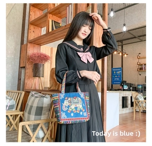 Detailed embroidery of an elephant motif on a blue canvas ethnic style handbag