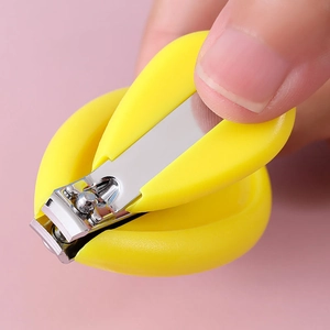 Shell-shaped baby safety nail clipper with ergonomic yellow handle on pink background
