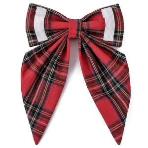 Detail of red and green plaid dog bowtie with elastic bands for collar attachment