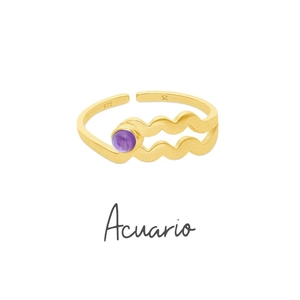 Detail of 18K gold wave ring with purple zircon stone and engraved 925 silver hallmark