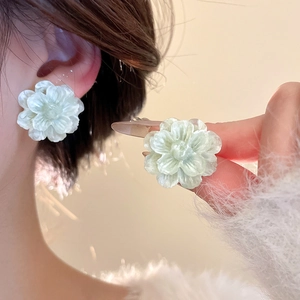 Detail of elegant acrylic flower stud earrings with multilayered translucent petals