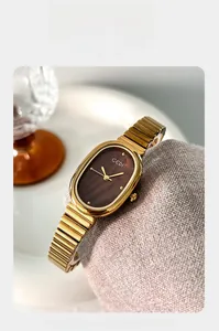 Close-up of GEDI women's oval gold watch with brown dial and vintage stretch band