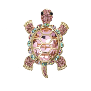 Fashionable gold turtle brooch with large pink gemstone and rainbow rhinestone shell accents