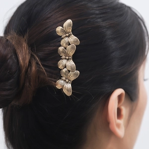 Vintage gold butterfly hair comb featuring three metallic butterflies on a side-view model