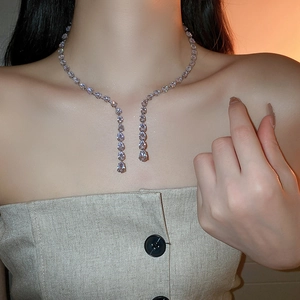 Close-up of sparkling pear-cut cubic zirconia drop choker necklace in silver