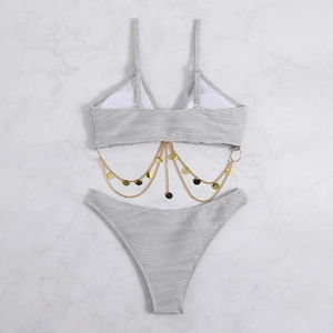 Detail of light gray ribbed bikini set featuring elegant gold chain with metal coin charms