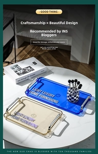 Close-up of rectangular serving trays with metal handles and modern printed text