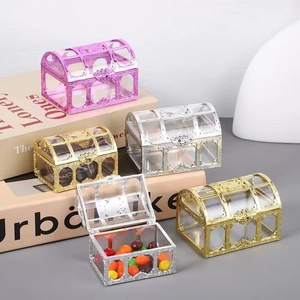 Detail view of colorful treasure chest shaped candy boxes in gold silver and pink