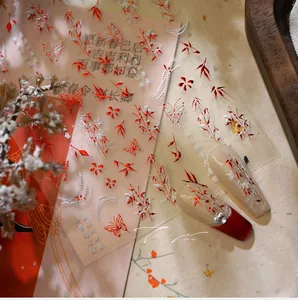 Detail of red and white bamboo and butterfly nail stickers with artistic ink style