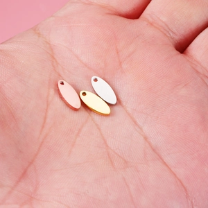 Oval stainless steel DIY jewelry pendants in rose gold, gold and silver held in hand