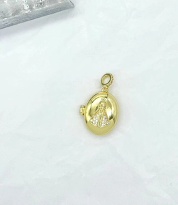 Detailed close-up of golden oval pendant featuring religious figure and inlaid crystals