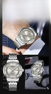 Detailed view of silver stainless steel business watch with day-date window and diamond hour markers