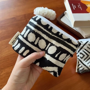 Detail of bohemian mini canvas wallet showing black and white tribal geometric patterns