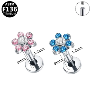 Macro detail of G23 titanium flower labret stud with internal thread and pink zircon
