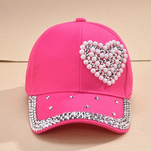 Pink baseball cap featuring pearl heart and rhinestone brim for a sparkling fashion look