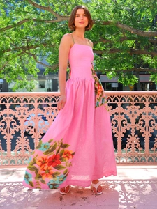 Detail of pink floral print summer dress featuring spaghetti straps and A-line skirt