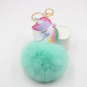 Colorful unicorn keychain with mint green faux fur pompom and golden metal ring
