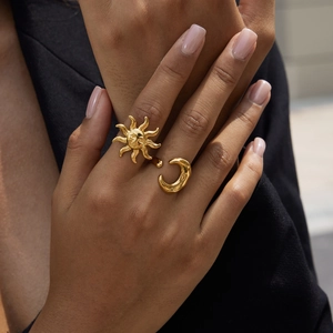 Close-up of 18K gold plated stainless steel ring featuring celestial sun and moon motifs