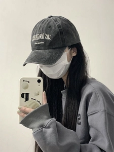 Mirror selfie showing washed dark grey denim baseball cap with Los Angeles embroidery