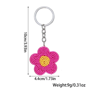 Detailed view of handmade beaded daisy keychain with specific dimensions and weight data