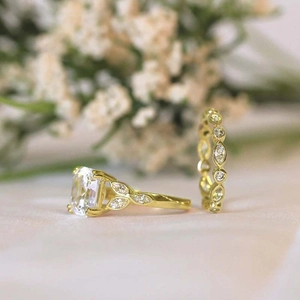 Detail of luxury gold engagement rings with cushion cut diamond and floral marquise band