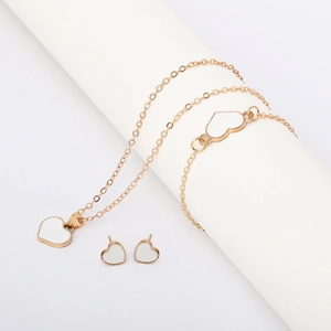 Elegant gold jewelry set with white heart pendants including necklace and earrings