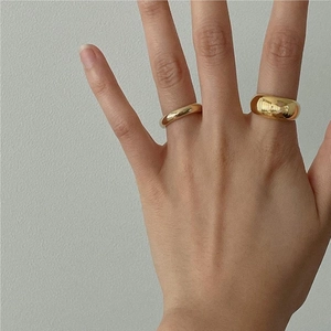 Set of minimalist 925 sterling silver dome rings in gold finish worn on hands