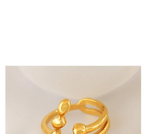 Macro detail of gold organic fluid open ring with irregular liquid design aesthetic