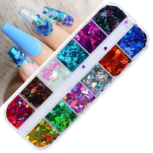 Macro shot of 12-grid heart nail sequins showing colorful laser glitter application on nails