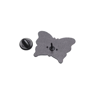 Macro shot of butterfly pin back with black rubber clutch on textured matte metal base