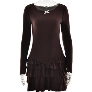 Detail of deep brown long sleeve dress with white bow neckline and tiered ruffled hem
