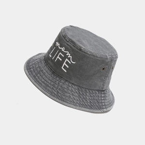 Detail view of washed cotton bucket hat featuring white mom LIFE embroidery and metal eyelets