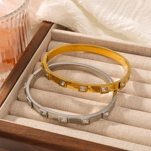 Minimalist 18k gold plated titanium steel bangles with square zircon in a wooden jewelry box