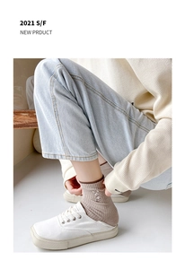 Detail view of brown cotton ribbed socks with cute white rabbit embroidery and soft texture