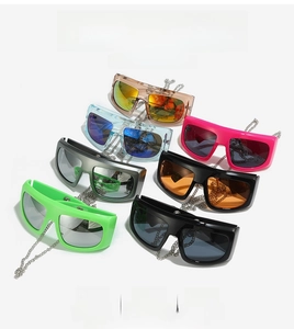 Collection of oversized Y2K shield sunglasses with metallic chains in seven vibrant colors